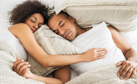 An African American couple sleeping